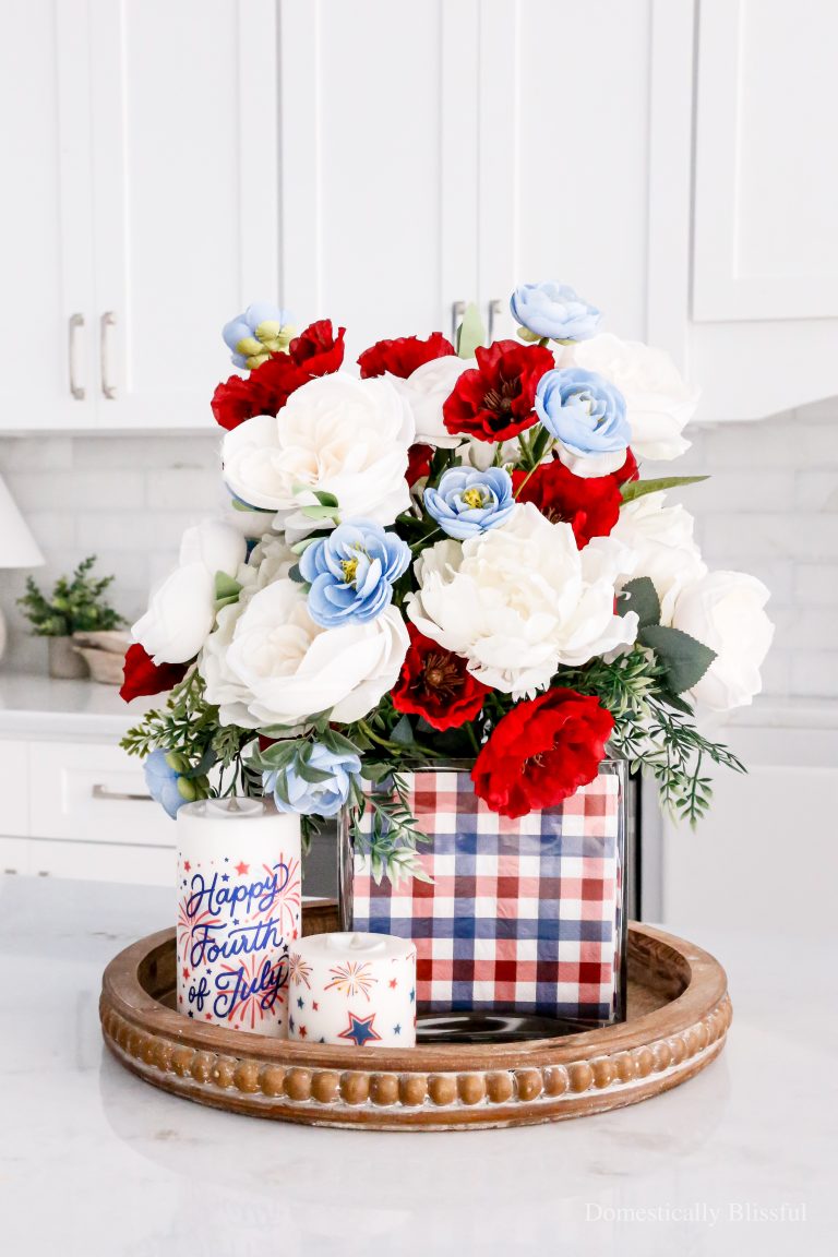 A simple 4th of July Napkin Centerpiece using Independence Day napkins and faux red, white, and blue flowers.