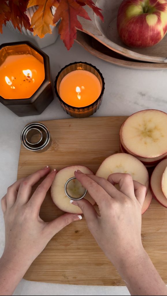These Apple Cinnamon Pastry Donuts are filled with fresh apple slices, surrounded by puff pastry, covered in cinnamon sugar, drizzled with caramel sauce, and topped with a cinnamon stick and edible maple leaf.