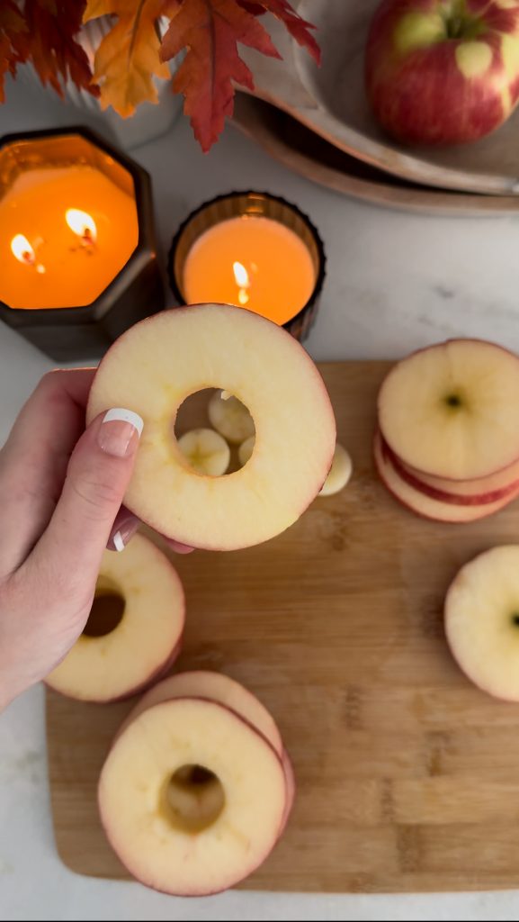 These Apple Cinnamon Pastry Donuts are filled with fresh apple slices, surrounded by puff pastry, covered in cinnamon sugar, drizzled with caramel sauce, and topped with a cinnamon stick and edible maple leaf.
