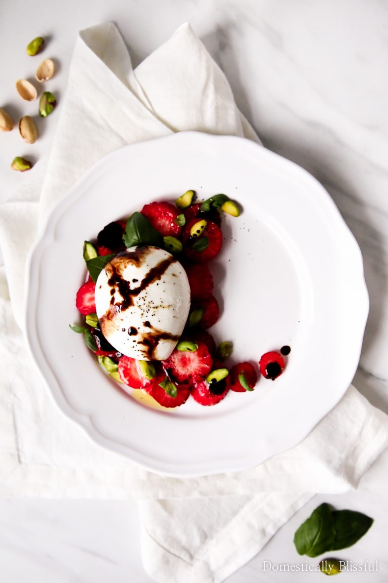 This Strawberry Burrata Salad is an easy appetizer to make & is topped with pistachios, basil, & a balsamic reduction.