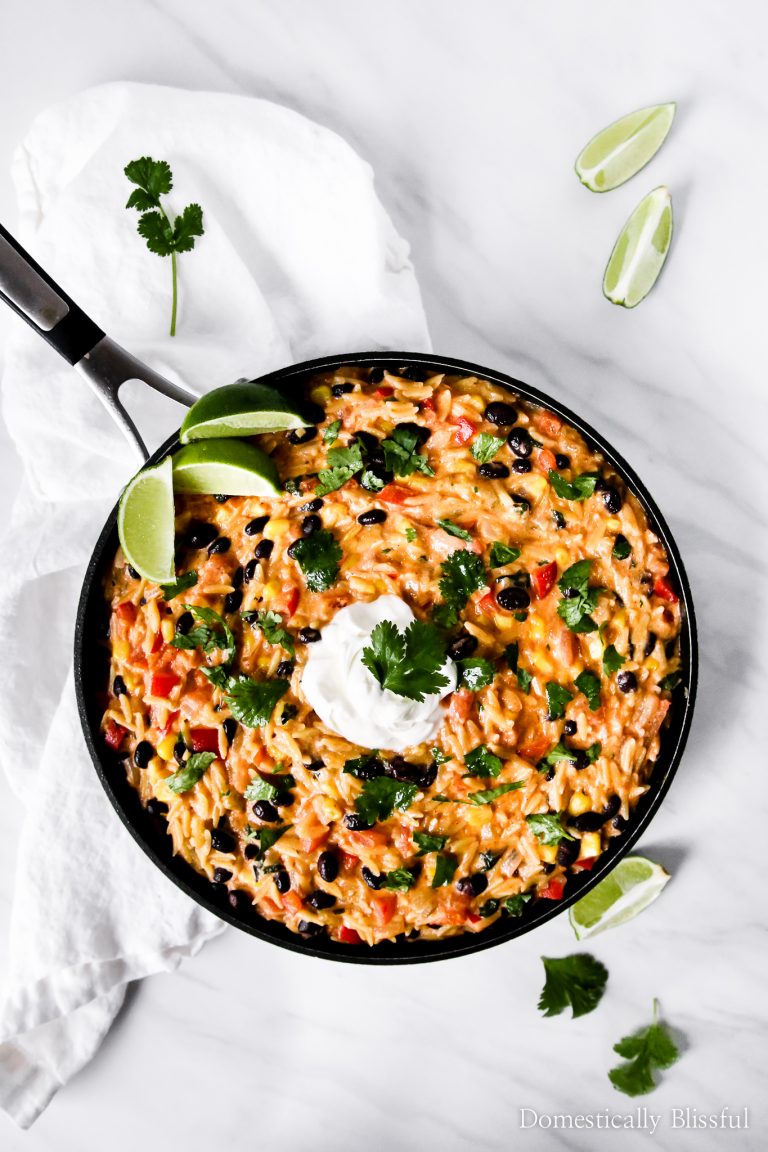 This Cheesy Enchilada Orzo is the perfect addition to your Mexican dinner & is loaded with corn, pepper, black beans, cilantro, & cheese!
