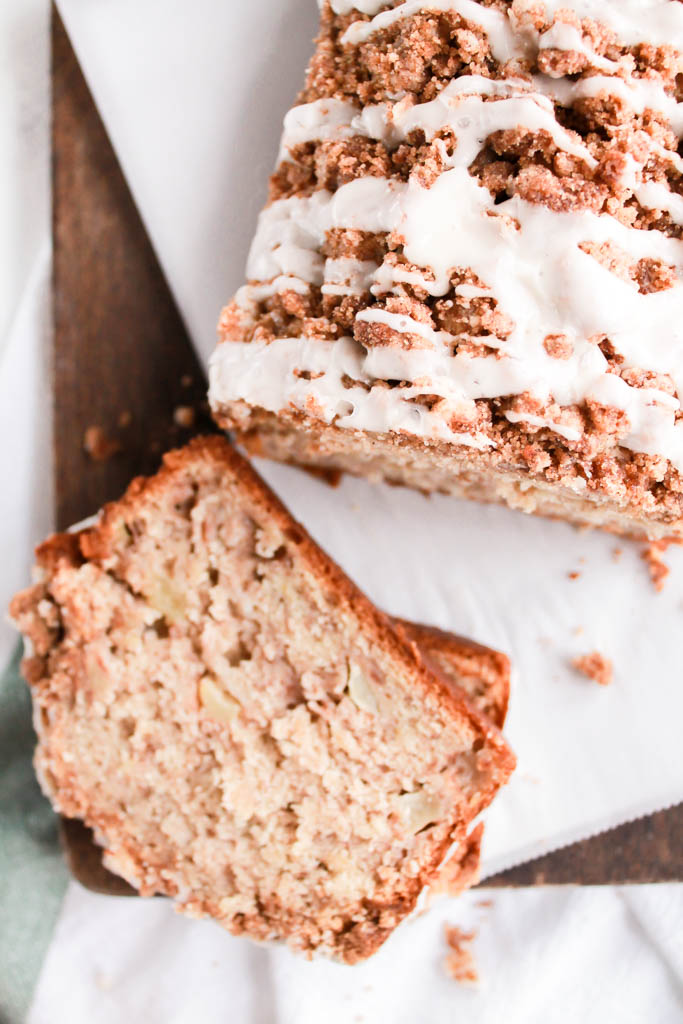 This Apple Cinnamon Banana Bread with streusel & icing drizzle is the perfect way to use up your extra apples & bananas & it makes your home smell as delicious as this bread tastes!