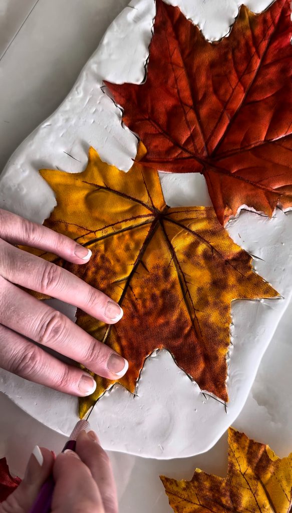 This DIY Clay Leaf Napkin Holder is a fun fall craft that makes a great gift and beautiful autumn decor for your kitchen.