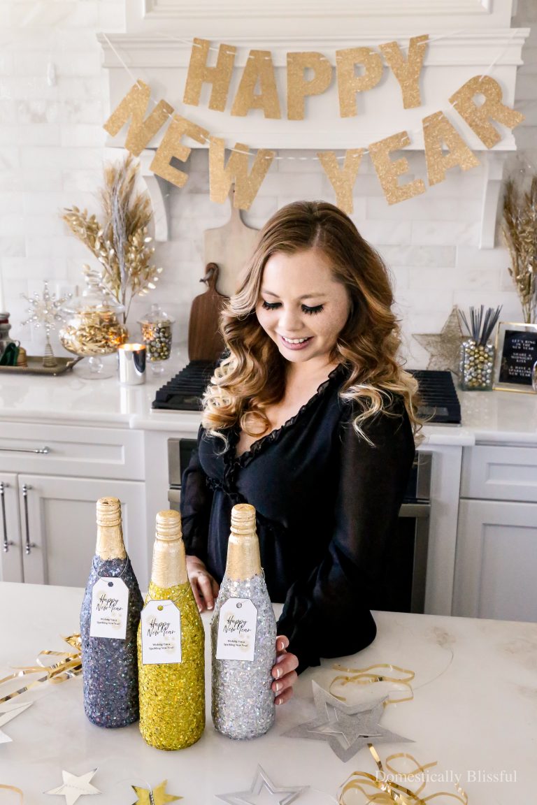 These DIY New Year's Eve Glittery Glass Bottles are a fun way to make your party drinks (we used sparkling juice) extra sparkly at your upcoming New Year's Eve celebration!