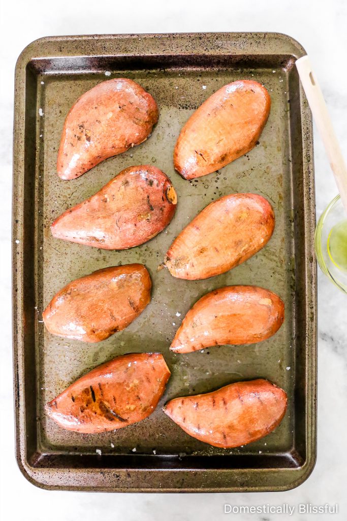 These Loaded Black Bean Taco Sweet Potatoes are covered in seasoned black beans and corn and topped with cheese, sour cream, salsa, guacamole, cilantro, and a squeeze of lime.