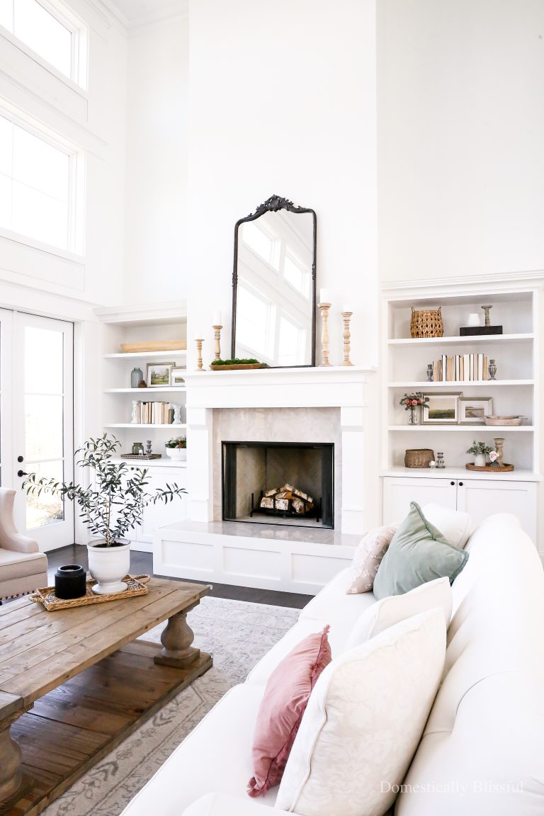 Simple Spring Living Room Decor with a little olive tree, spring prints, fresh and artificial flowers, and hints of spring colors.