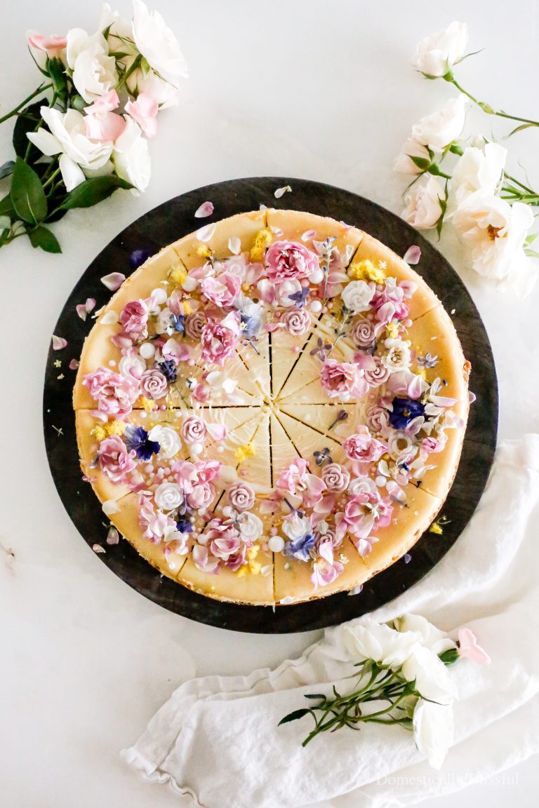 This Freeze-Dried Flowers Cheesecake is topped with a white chocolate drizzle, sprinkles, edible sugar flowers, and freeze-dried real flowers to create a very beautiful spring and summer cheesecake.