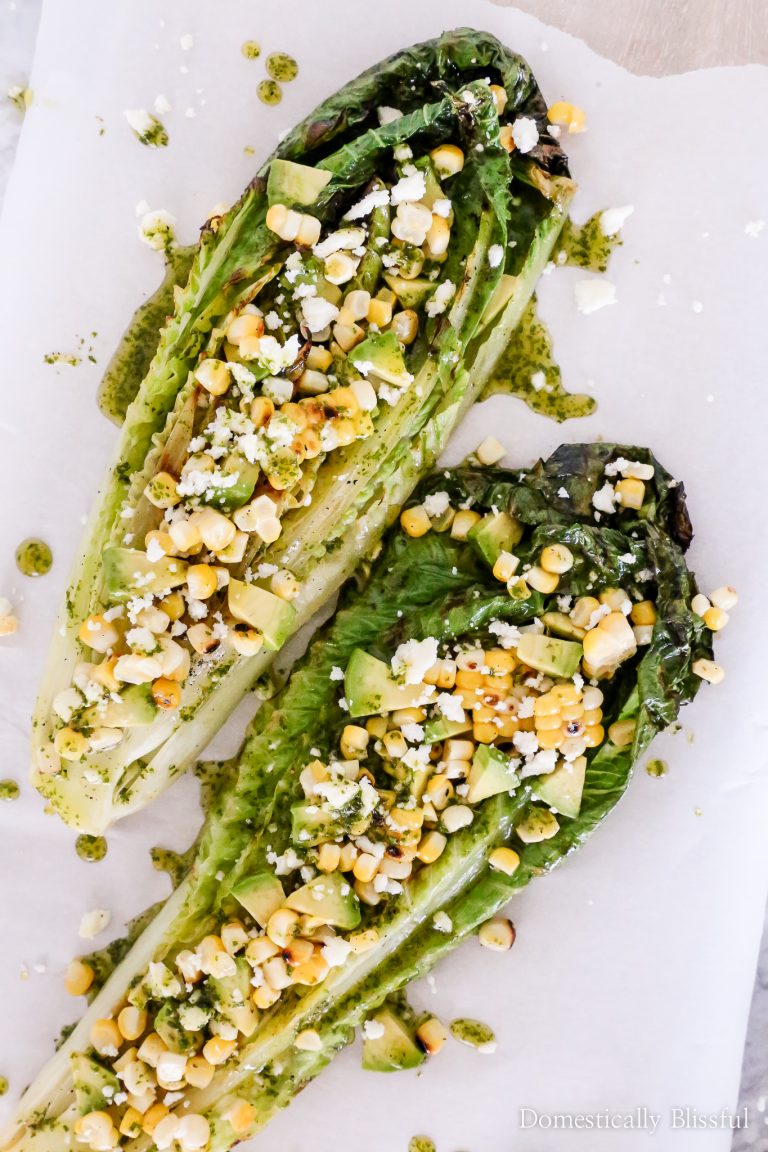This Grilled Romaine Mexican Salad is topped with roasted corn, avocado, queso fresco, and a homemade Cilantro Honey Lime Dressing.