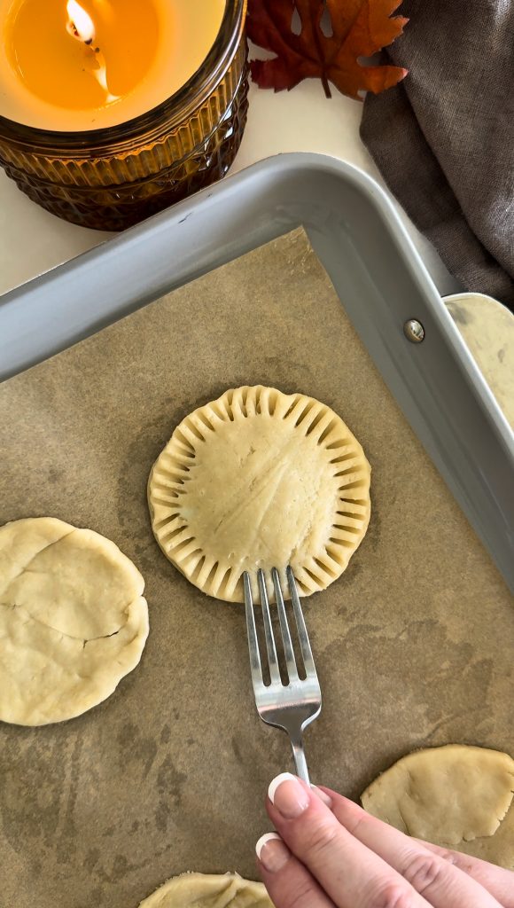 These Homemade Pumpkin Pop Tarts are made with pie crust and have a sweet pumpkin filling topped with orange icing and sprinkles, making them perfect for a fall party or Thanksgiving brunch.