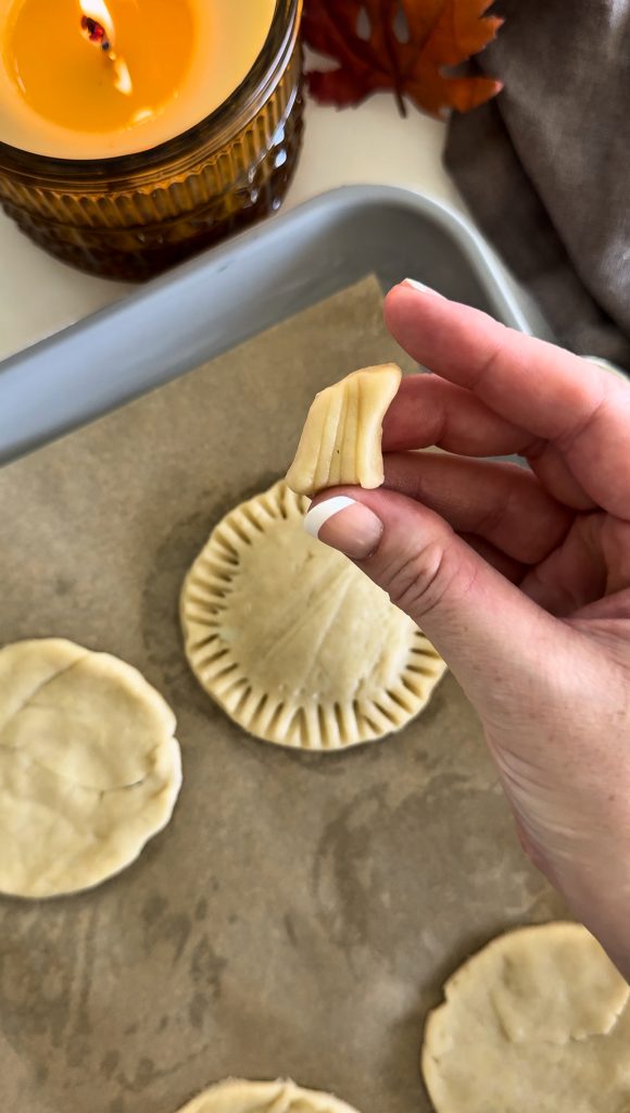 These Homemade Pumpkin Pop Tarts are made with pie crust and have a sweet pumpkin filling topped with orange icing and sprinkles, making them perfect for a fall party or Thanksgiving brunch.