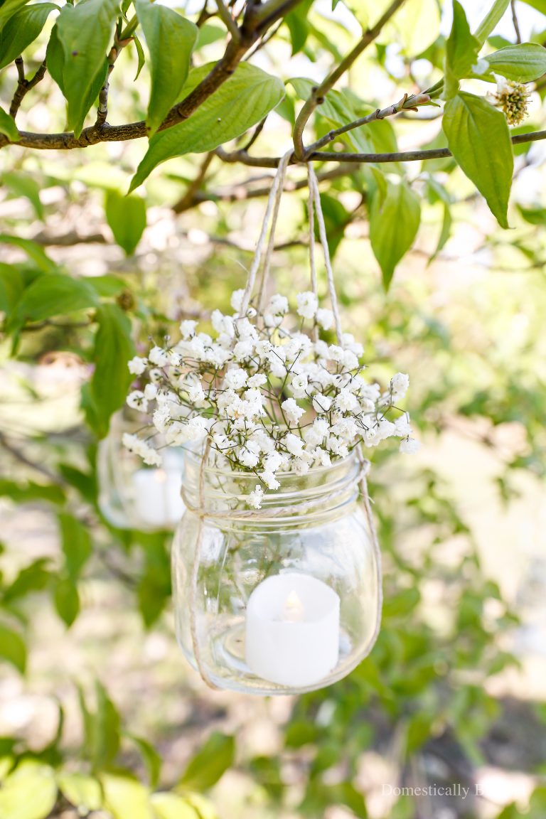 How to hang glass jars to use as beautiful summer outdoor decorations.