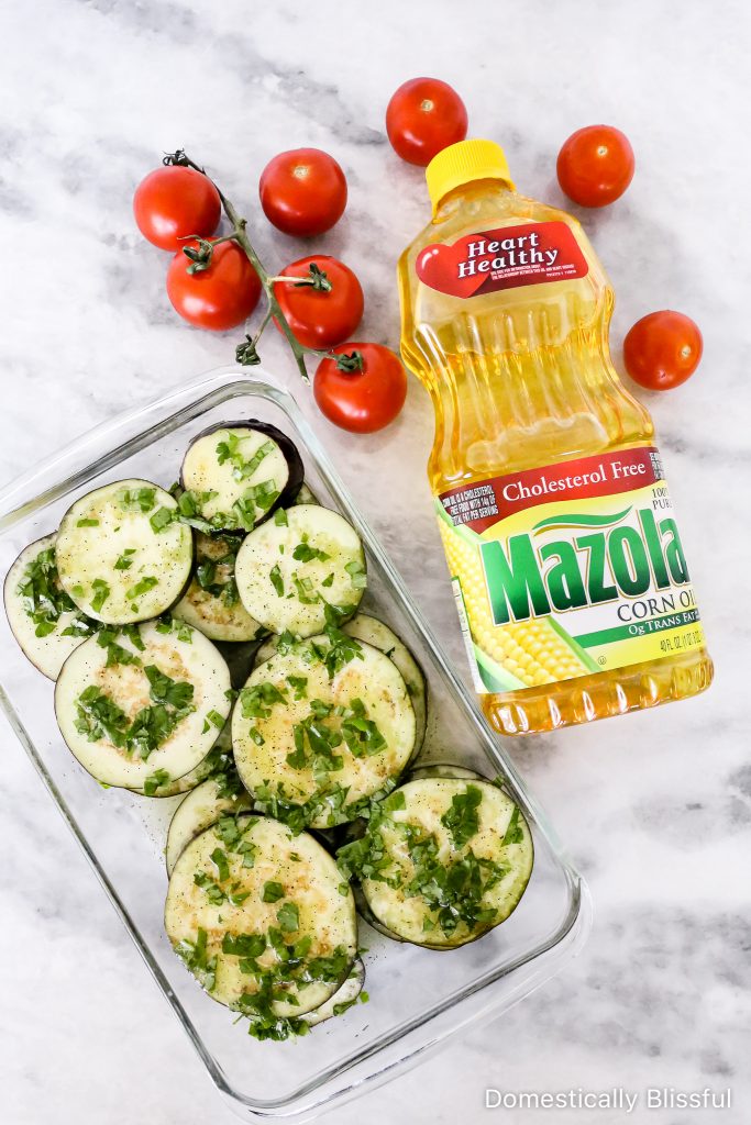 This Grilled Eggplant Salad is marinated, grilled, and topped with whipped ricotta, pesto, quartered tomatoes, and fresh herbs.