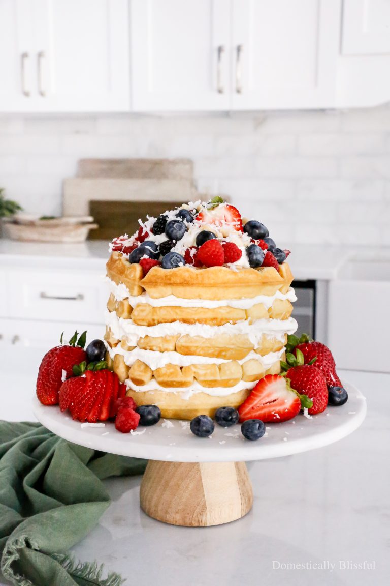 This Mochi Waffle Cake is made with homemade whipped cream, and mochi waffles that are beautifully golden brown with a light and chewy center, and topped with lots of fruit.