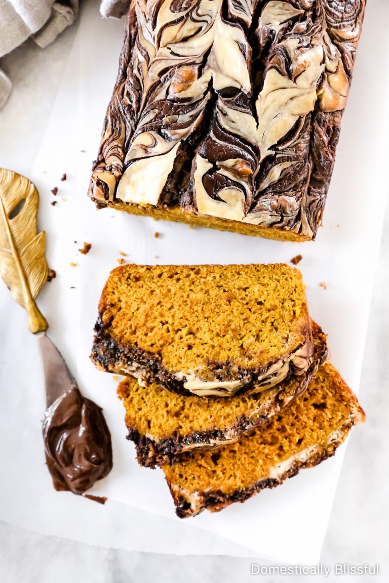 This Nutella Cream Cheese Swirl Pumpkin Bread is a festive fall recipe and is a soft pumpkin spice bread with a swirl of Nutella and sweet cream cheese on top.