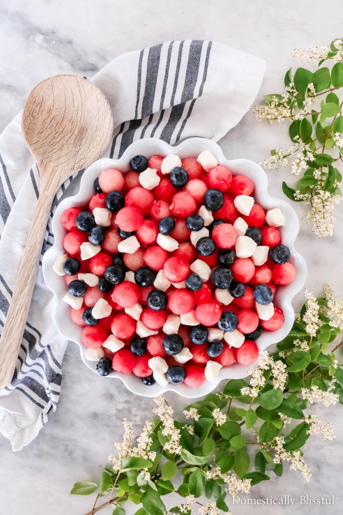 This Patriotic Fruit Caprese is a fun way to enjoy your favorite summer fruit and mini mozzarella balls on 4th of July.