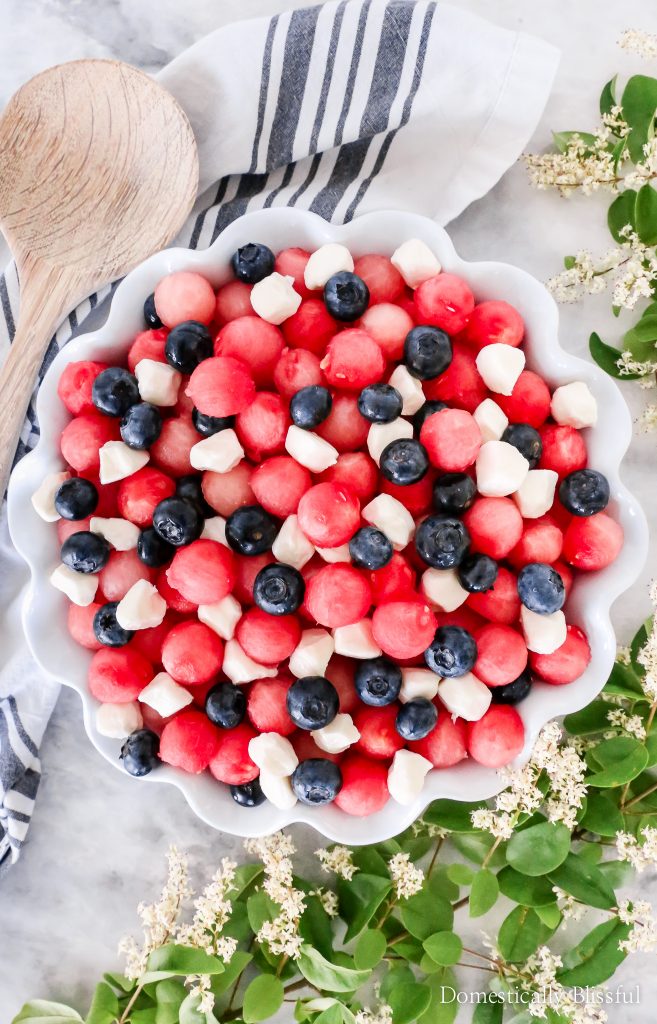 This Patriotic Fruit Caprese is a fun way to enjoy your favorite summer fruit and mini mozzarella balls on the 4th of July.