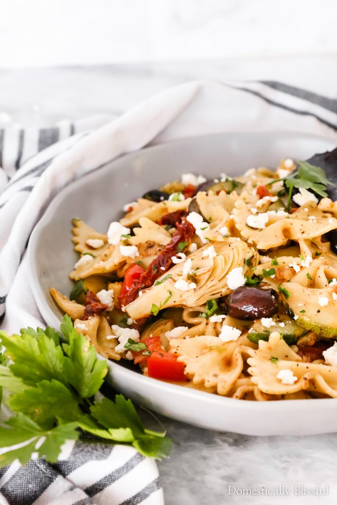This Quick Mediterranean Pasta can be made in 15 minutes and is filled with a variety of colorful ingredients for a fun vegetarian dinner!