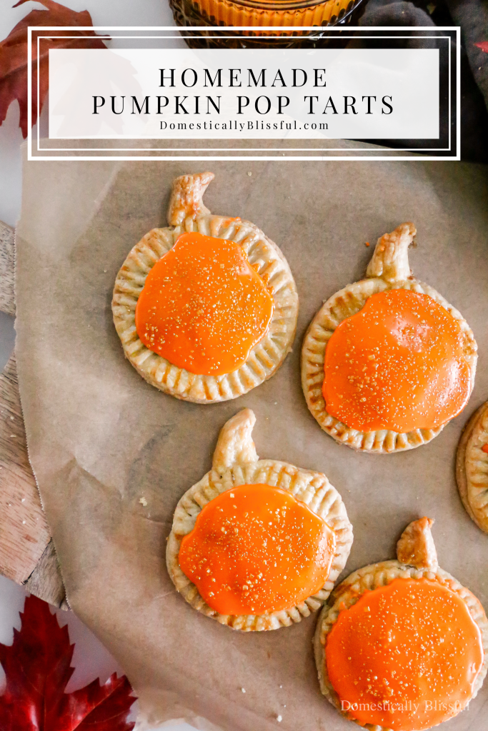 These Homemade Pumpkin Pop Tarts are made with pie crust and have a sweet pumpkin filling topped with orange icing and sprinkles, making them perfect for a fall party or Thanksgiving brunch.